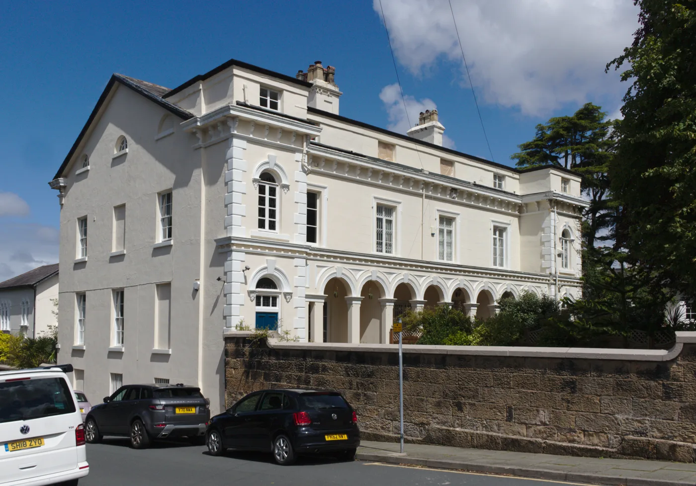 20 to 24 Village Road, Oxton. The council's own appraisal lists numbers 20, 22 and 24 as listed buildings, and names the sandstone boundary walls in front of them as a defining feature of the conservation area